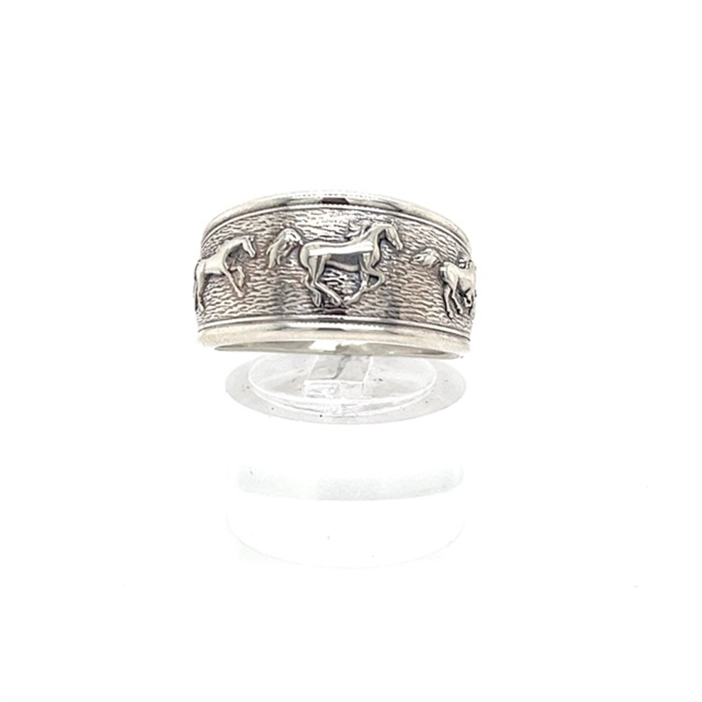 The Kabana SS Thick Running Horse Ring, size 8, features engraved horses in motion and is displayed upright on a clear stand against a white background.