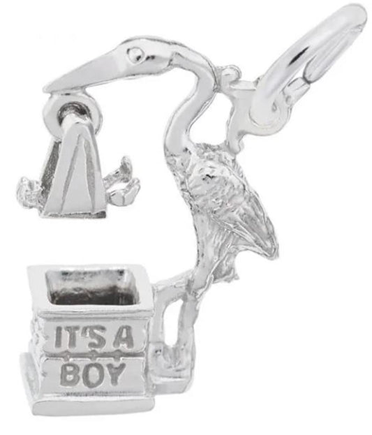 The "It's A Boy Stork" charm by Rembrandt Charms is a sterling silver piece depicting a stork in flight with open wings, carrying a baby cradle. The base is engraved with the text "IT'S A BOY," capturing intricate details of the stork's posture and texture. This charm adds timeless elegance to any jewelry collection.