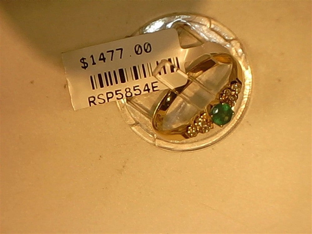 The Ryan Gems Small Round Emerald and Diamond ring, crafted in 14k yellow gold (size 7.5), is displayed on a round stand with a $1477.00 price tag and code RSP5854E.