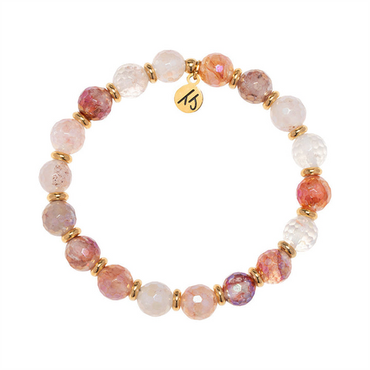 Part of T Jazelle’s Gold Empowered Elegance Collection, the Strawberry Quartz Gemstone Bracelet features faceted pink stones with gold spacers and a gold “15” charm for added elegance.