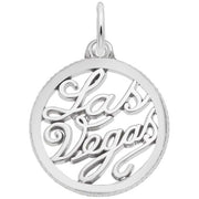 The Las Vegas Charm from Rembrandt Charms is a round sterling silver pendant featuring the words "Las Vegas" written in an intricate cursive script in the center. The connected letters create an elegant, openwork style, and it includes a small loop at the top for easy attachment to a chain.