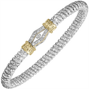 The 4mm Objecif Diamond Bangle Bracelet by Alwand Vahan Jewelry features a textured silver band with a gold and diamond-accented clasp at the center, showcasing a unique geometric design—an exquisite diamond bangle that brings refined elegance to any look.