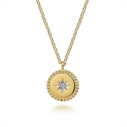 This exquisite 14K Yellow Gold Bujukan Medallion Necklace from Gabriel & Co features a circular pendant adorned with a raised border and a Starburst Diamond Center, elegantly suspended from a gold chain composed of interlinked oval-shaped links.