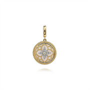 The 14K Yellow Gold Bujukan Diamond and Mother of Pearl Medallion Pendant from Gabriel & Co's Bujukan Collection features a circular design with an intricate flower pattern at its center. Adorned with small sparkling gemstones, this exquisite pendant also boasts a delicate beaded border around its edge and a polished gold bail for easy attachment to a chain.