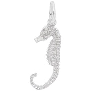 The Rembrandt Charms Seahorse Charm in Sterling Silver features a textured body and hangs from a small ring. This intricately designed charm captures the essence of the marine creature with its curled tail, ridged back, and prominent snout, all brought to life in a shiny metallic finish.