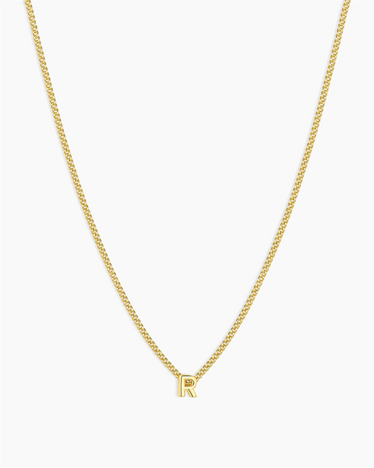 The Gorjana Wilder Mini Alphabet Necklace - R features an 18k gold plated, small "R" pendant at the center, shown on a plain white background—a perfect minimalist piece for daily wear.