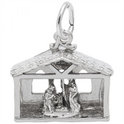 The Nativity Charm in sterling silver by Rembrandt Charms features a detailed depiction of Mary, Joseph, and baby Jesus in a stable with intricately designed windows and a textured roof. It is attached to a small hoop, making it perfect for wearing on a bracelet or necklace.