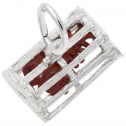 A close-up image of a Rembrandt Charms sterling silver Lobster Trap Charm. The intricately designed cage features a small red shark figure inside and an attached silver loop on top for a chain. This piece of jewelry showcases elaborate metalwork with bars, reminiscent of a lobster trap, and detailed shark elements.