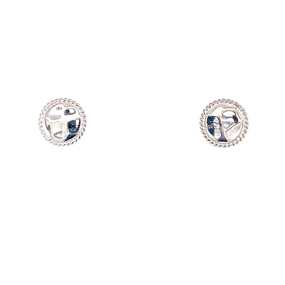 The Sterling Silver Hammered Studs by Anna Beck Designs are artfully displayed against a white background, showcasing their small, round shape with a braided border and a textured center design.