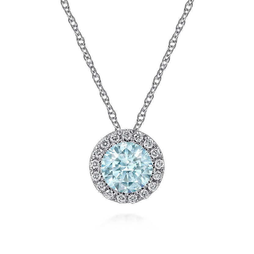 The Gabriel & Co 14K White Gold Aquamarine and Diamond Halo Pendant Necklace features a round blue gemstone with sparkling diamond accents, suspended on a delicate chain and displayed against a white background.