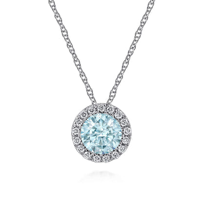 The Gabriel & Co 14K White Gold Aquamarine and Diamond Halo Pendant Necklace features a round blue gemstone with sparkling diamond accents, suspended on a delicate chain and displayed against a white background.