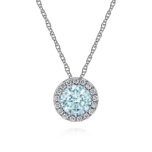 The Gabriel & Co 14K White Gold Aquamarine and Diamond Halo Pendant Necklace features a round blue gemstone with sparkling diamond accents, suspended on a delicate chain and displayed against a white background.