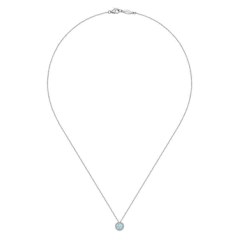 The Gabriel & Co 14K White Gold Aquamarine and Diamond Halo Pendant Necklace features a light blue gemstone encircled by sparkling diamonds, suspended from a fine chain and showcased against a white background.