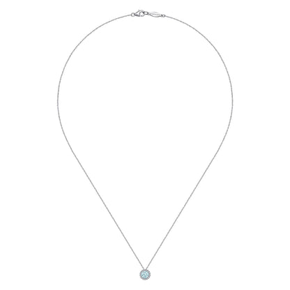 The Gabriel & Co 14K White Gold Aquamarine and Diamond Halo Pendant Necklace features a light blue gemstone encircled by sparkling diamonds, suspended from a fine chain and showcased against a white background.