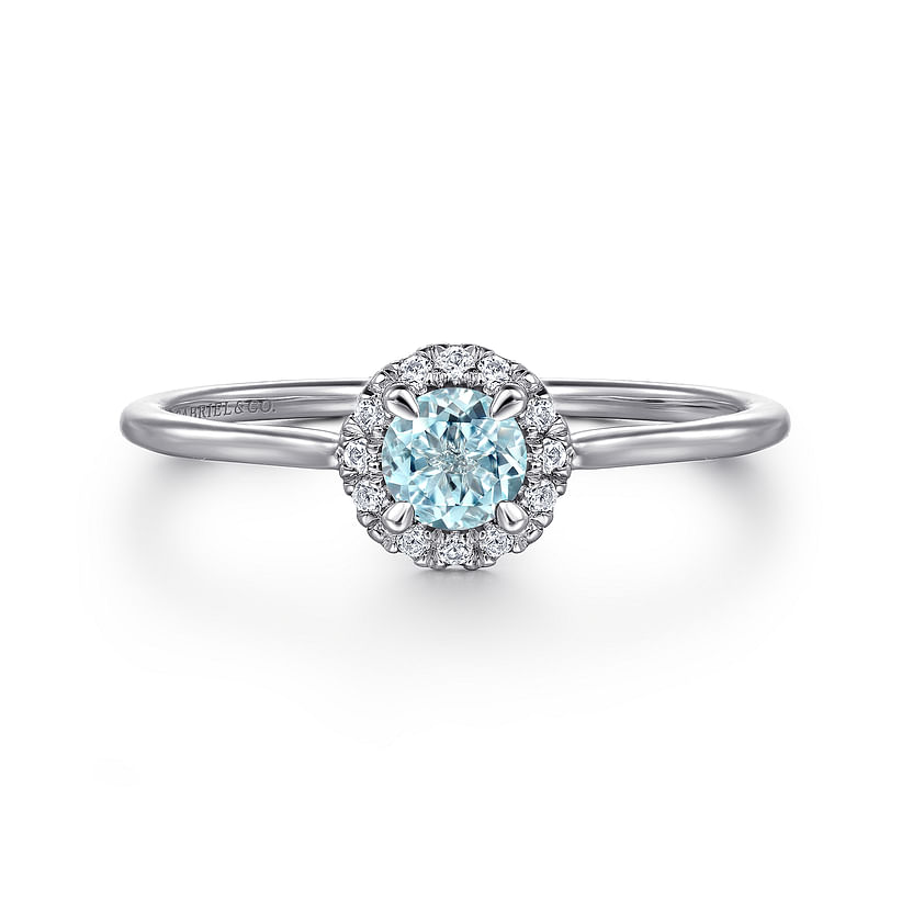 The Gabriel & Co 14K White Gold Aquamarine and Diamond Halo Ring features a stunning aquamarine center stone encircled by sparkling diamonds, shown against a plain white background.