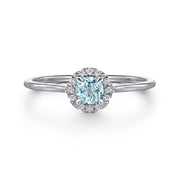 The Gabriel & Co 14K White Gold Aquamarine and Diamond Halo Ring features a stunning aquamarine center stone encircled by sparkling diamonds, shown against a plain white background.