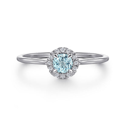 The Gabriel & Co 14K White Gold Aquamarine and Diamond Halo Ring features a stunning aquamarine center stone encircled by sparkling diamonds, shown against a plain white background.