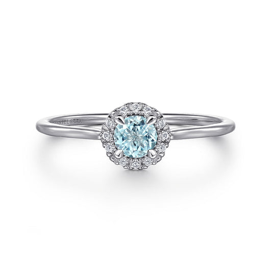 The Gabriel & Co 14K White Gold Aquamarine and Diamond Halo Ring features a stunning aquamarine center stone encircled by sparkling diamonds, shown against a plain white background.