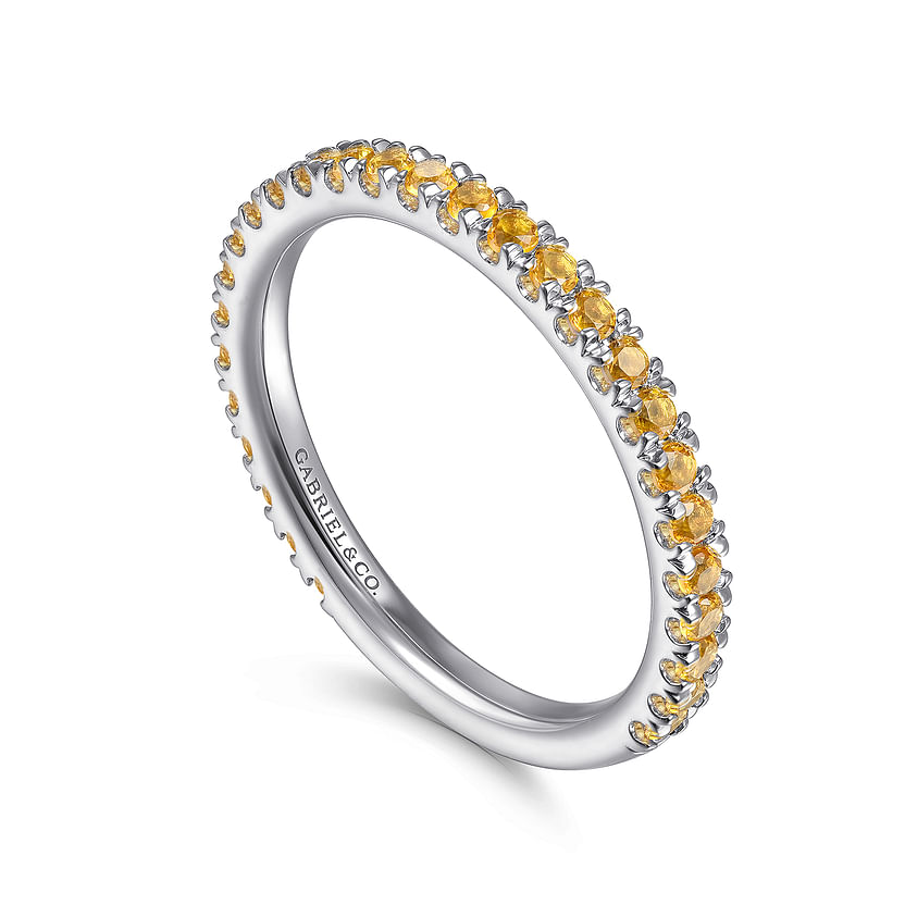 The Gabriel & Co 14K White Gold Citrine Stackable Ring features small round yellow gemstones around the band and "CARAT & CO." engraved inside, shown on a white background.