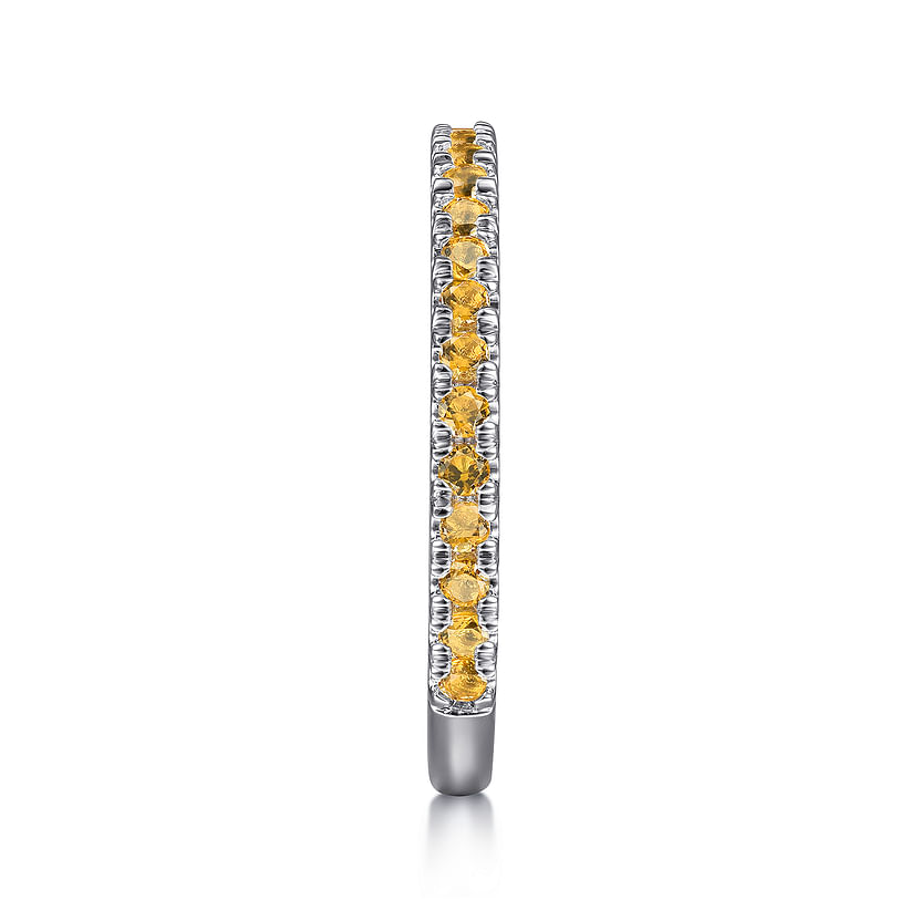 The Gabriel & Co 14K White Gold Citrine Stackable Ring showcases a slim band with a single row of round yellow citrine gemstones, displayed vertically on a white background.