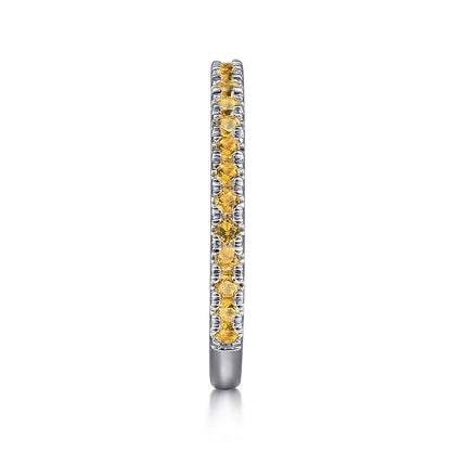 The Gabriel & Co 14K White Gold Citrine Stackable Ring showcases a slim band with a single row of round yellow citrine gemstones, displayed vertically on a white background.