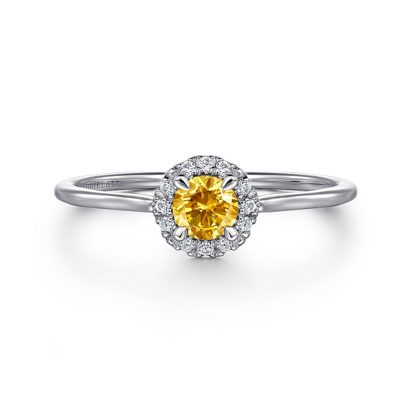 The Gabriel & Co 14K White Gold Citrine and Diamond Halo Promise Ring features a round yellow citrine center, encircled by sparkling diamonds, elegantly displayed on a white background.