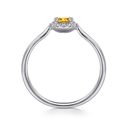 Side view of the Gabriel & Co 14K White Gold Citrine and Diamond Halo Promise Ring, showcasing a round yellow citrine in a claw setting with a diamond halo and a sleek band that accentuates the vibrant center stone.