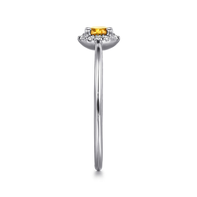 Side view of the Gabriel & Co 14K White Gold Citrine and Diamond Halo Promise Ring, showcasing a yellow citrine in a prong setting with a diamond halo on a slender band against a white background.