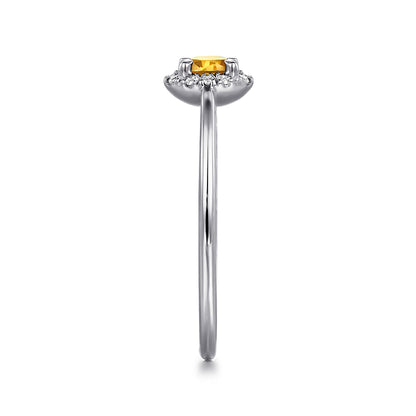 Side view of the Gabriel & Co 14K White Gold Citrine and Diamond Halo Promise Ring, showcasing a yellow citrine in a prong setting with a diamond halo on a slender band against a white background.
