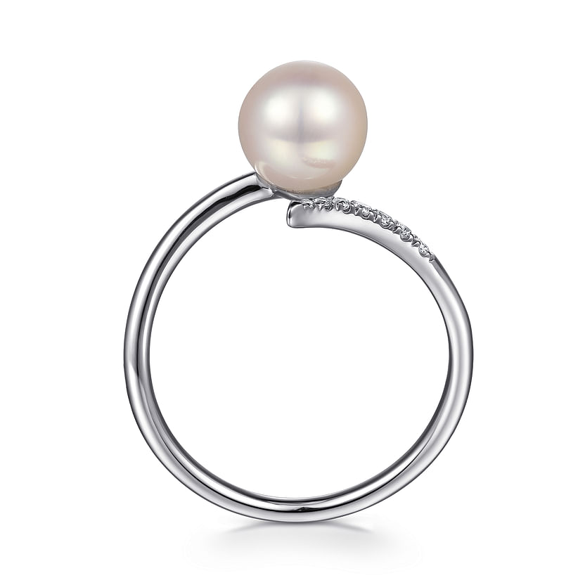 The Gabriel & Co 14K White Gold Cultured Pearl and Diamond Open Wrap Ring features a round white pearl and a row of small diamonds set on part of the band, elegantly displayed on a white background.