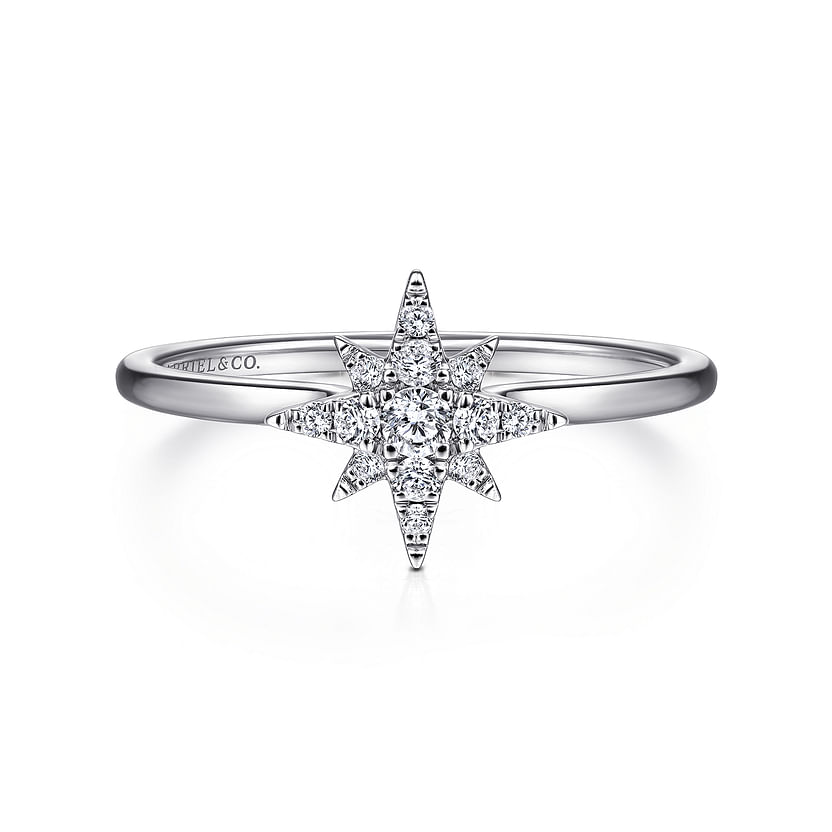 The Gabriel & Co 14K White Gold Diamond Starburst Ring features a central round diamond with a celestial-inspired starburst design accented by smaller diamonds, elegantly displayed against a white background.