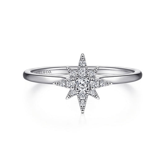 The Gabriel & Co 14K White Gold Diamond Starburst Ring features a central round diamond with a celestial-inspired starburst design accented by smaller diamonds, elegantly displayed against a white background.