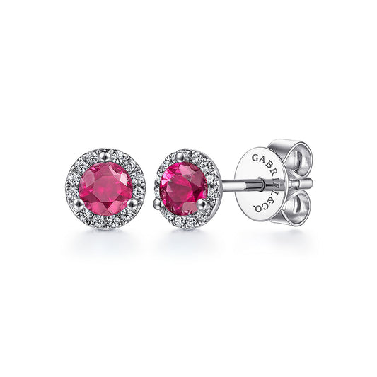 Gabriel & Co's 14K white gold stud earrings feature vibrant round rubies encircled by pavé-set natural diamonds with butterfly backs, engraved "GABRIEL & CO."—a stunning diamond and ruby combination.