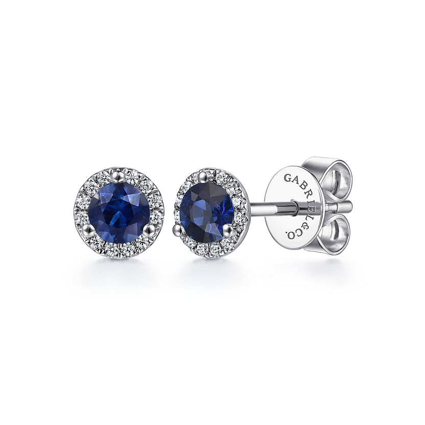 Gabriel & Co 14K White Gold Diamond and Sapphire Stud Earrings feature round blue sapphires with a halo of diamonds—engraved on the backings—making them perfect September birthstone jewelry.