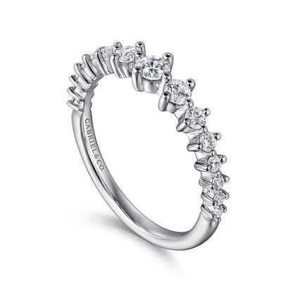 The Gabriel & Co 14K White Gold Graduating Diamond Classic Ladies Ring features a central diamond with smaller diamonds along the band and an inside engraving. Perfect for stacking and adding a touch of luxury.