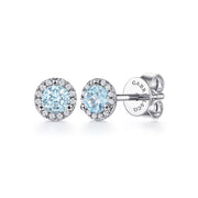 Gabriel & Co 14K White Gold Halo Aquamarine and Diamond Stud Earrings feature round light blue aquamarine centers encircled by small white diamonds with butterfly backs; the brand name is engraved on the back.
