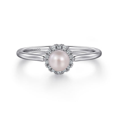 The Gabriel & Co 14K White Gold Pearl Ring with Diamond Halo features a central round pearl surrounded by sparkling diamonds, shown on a plain white background.
