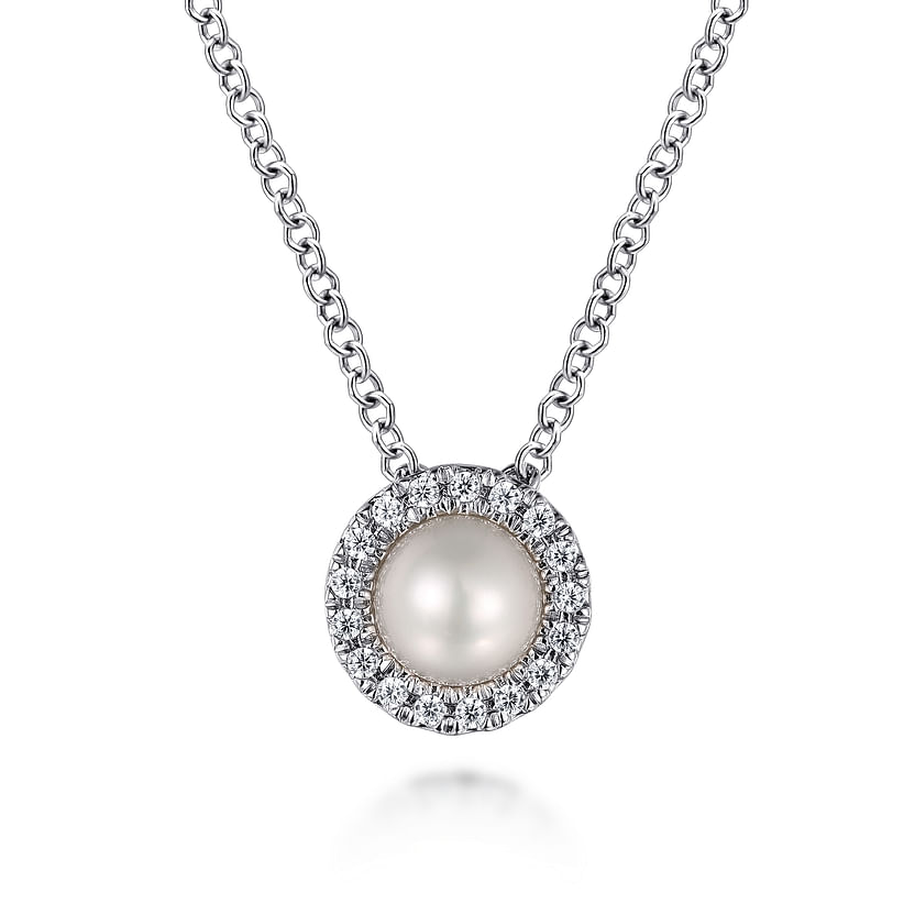The Gabriel & Co 14K White Gold Pearl and Diamond Halo Pendant Necklace features a round pearl surrounded by sparkling diamonds, elegantly suspended from a fine chain.