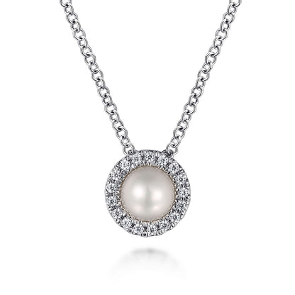 The Gabriel & Co 14K White Gold Pearl and Diamond Halo Pendant Necklace features a round pearl surrounded by sparkling diamonds, elegantly suspended from a fine chain.