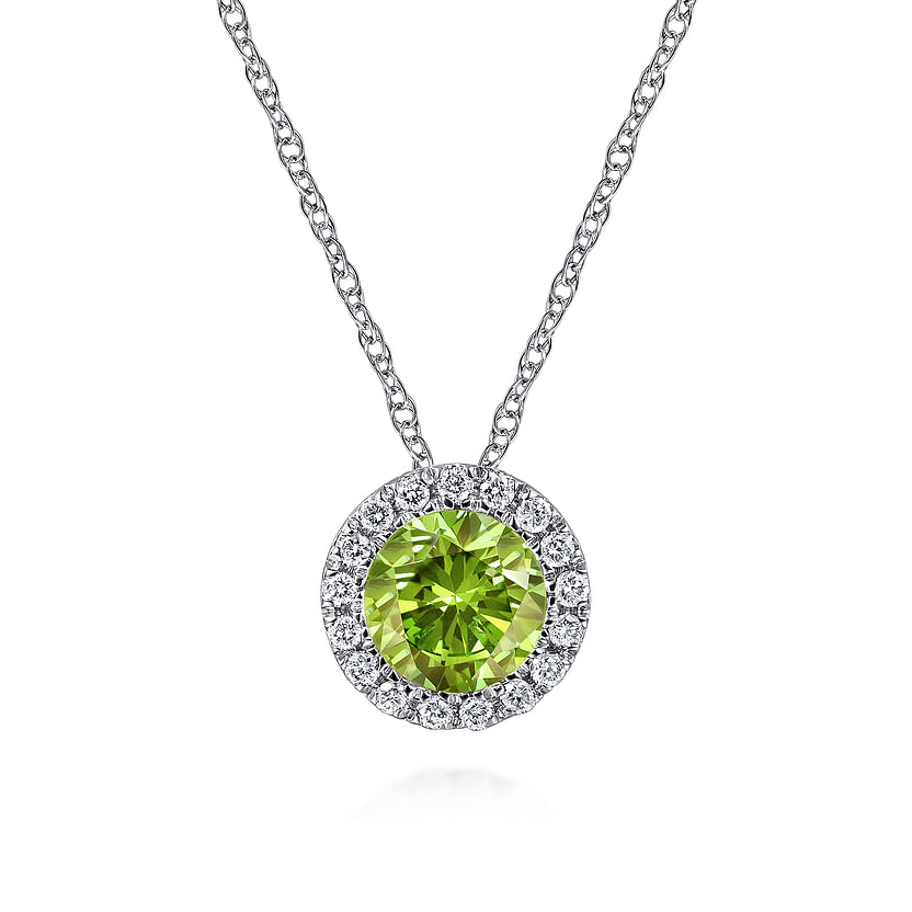 The Gabriel & Co 14K White Gold Peridot and Diamond Halo Pendant Necklace features a round green peridot surrounded by sparkling diamonds, elegantly displayed on a white background.