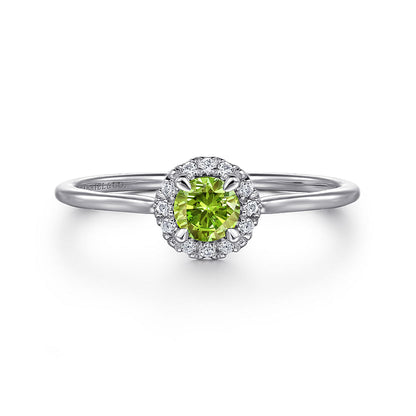 The Gabriel & Co 14K White Gold Peridot and Diamond Halo Promise Ring features a round green peridot center, accented with a sparkling diamond halo and shown against a white background.