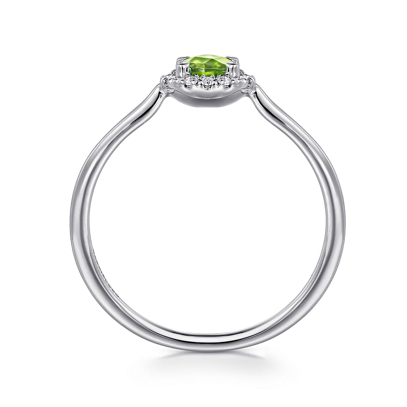 The Gabriel & Co 14K White Gold Peridot and Diamond Halo Promise Ring features a round green peridot center stone with a sparkling diamond halo, shown from the side against a white background.