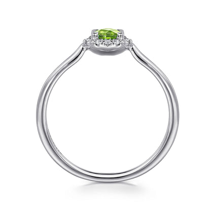 The Gabriel & Co 14K White Gold Peridot and Diamond Halo Promise Ring features a round green peridot center stone with a sparkling diamond halo, shown from the side against a white background.