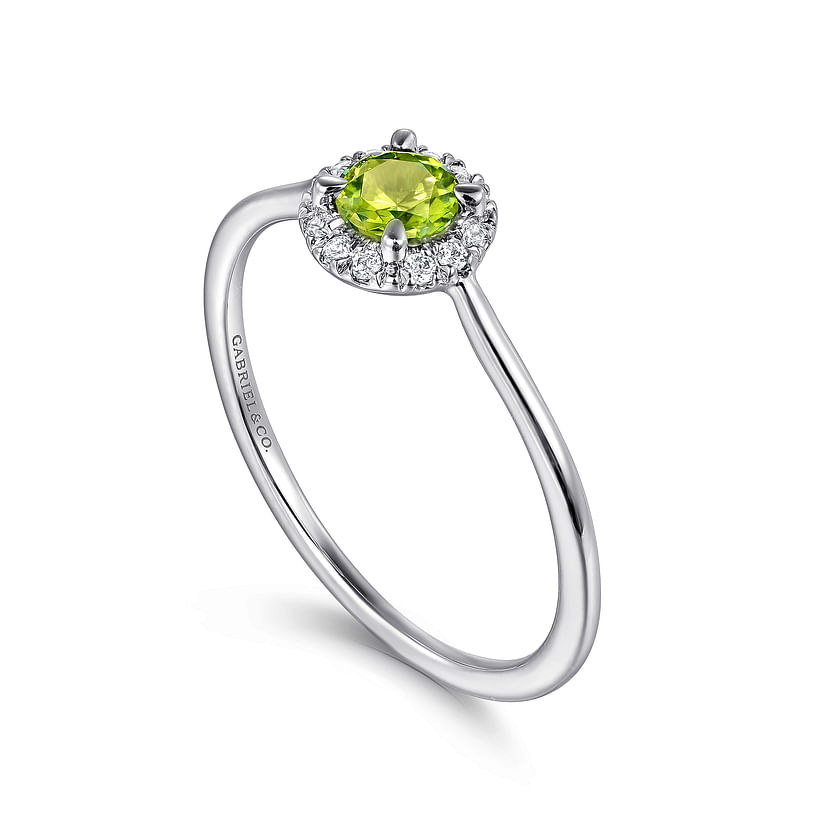 The Gabriel & Co 14K White Gold Peridot and Diamond Halo Promise Ring features a round green peridot center stone encircled by sparkling diamonds, shown against a white background.