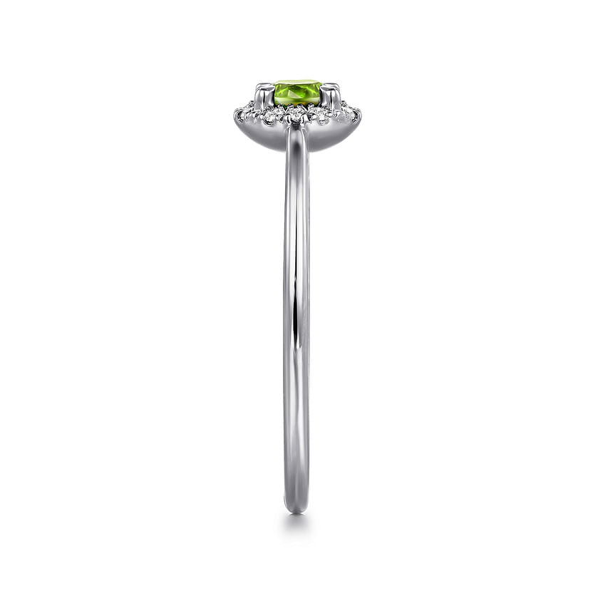 Side view of the Gabriel & Co 14K White Gold Peridot and Diamond Halo Promise Ring, showcasing a small rectangular green peridot at the center, framed by a diamond halo on a slim, polished band.