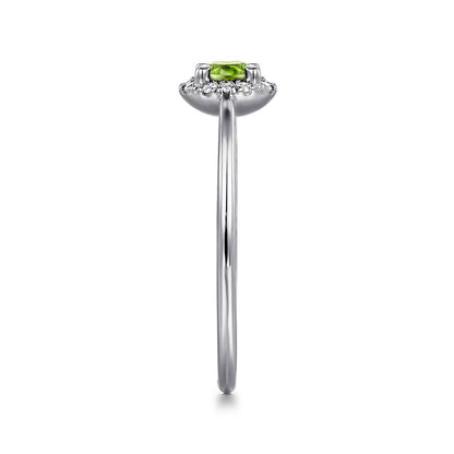 Side view of the Gabriel & Co 14K White Gold Peridot and Diamond Halo Promise Ring, showcasing a small rectangular green peridot at the center, framed by a diamond halo on a slim, polished band.