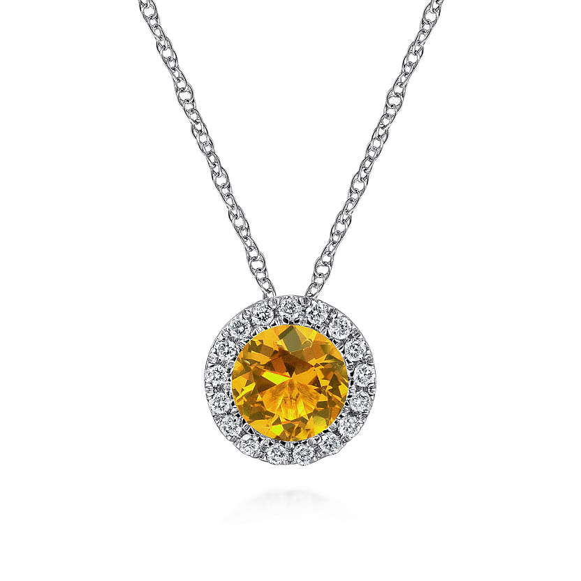 The Gabriel & Co 14K White Gold Round Citrine and Diamond Halo Pendant Necklace features a vibrant citrine center surrounded by sparkling diamonds, creating an elegant statement piece.