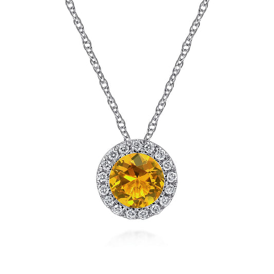 The Gabriel & Co 14K White Gold Round Citrine and Diamond Halo Pendant Necklace features a vibrant citrine center surrounded by sparkling diamonds, creating an elegant statement piece.