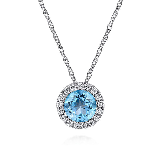 The Gabriel & Co 14K White Gold Round Swiss Blue Topaz and Diamond Halo Pendant Necklace features a round Swiss blue topaz encircled by diamonds on a delicate chain, shown against a white background.