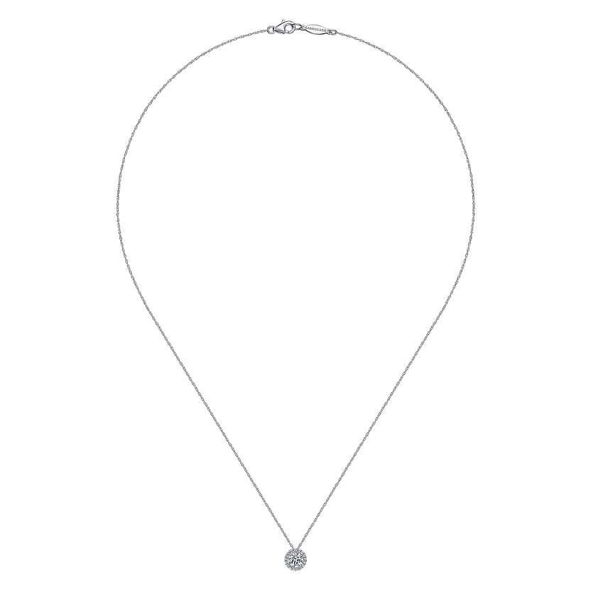 The Gabriel & Co 14K White Gold White Sapphire and Diamond Halo Necklace features a thin chain with a sparkling round pendant, showcased against a white background.